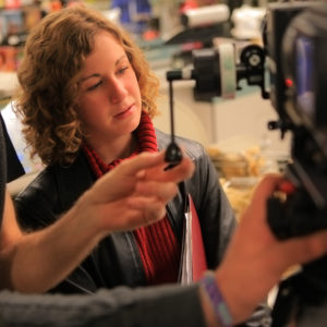 Film director watches the monitor as the take is being shot.